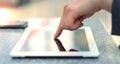 Woman hand touching screen on modern digital tablet pc. Close-up image with shallow depth of field focus on finger Royalty Free Stock Photo