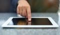 Woman hand touching screen on modern digital tablet pc. Close-up image with shallow depth of field focus on finger Royalty Free Stock Photo