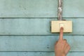 Woman hand are turning on or off to old electrical light switch with old vintage light blue wood wall background Royalty Free Stock Photo