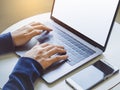 Woman hand type on Laptop Keyboard with smart phone Business concept Royalty Free Stock Photo