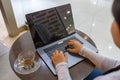 Woman hand typing laptop keyboard at round coffee table Royalty Free Stock Photo