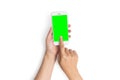 Woman hand use finger touch on mobile phone button with blank green screen from top view, isolated on white background