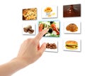 Woman hand uses touch screen interface with food