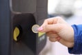 Woman hand using coin to pay parking meter Royalty Free Stock Photo
