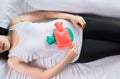 Woman hand using hot water bag or bottle on her belly on bedroom,Female suffering from abdominal pain,Period cramps Royalty Free Stock Photo