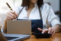 Woman hand using a laptop, smartphone and tablet and writing notebook at the office of her business online shopping. In home Royalty Free Stock Photo