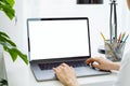 Woman hand using laptop on the table in house, mock up of blank screen. Royalty Free Stock Photo