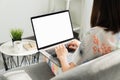 Woman hand using laptop on the table in house, mock up of blank screen. Royalty Free Stock Photo