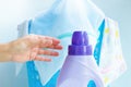 Woman hand using liquid laundry softener detergent washing cloth