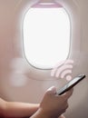 Woman hand using smart phone on the airplane, wifi