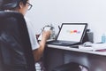 Woman hand using smart phone and laptop at home office. Royalty Free Stock Photo