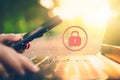 Woman hand using smart phone and laptop with lock icon at outdoor nature park and sunset sky with bokeh light abstract background Royalty Free Stock Photo