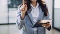 Woman hand using smart phone and laptop in outdoor nature park and sunset sky with bokeh light abstract background. Technology Royalty Free Stock Photo