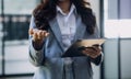 Woman hand using smart phone and laptop in outdoor nature park and sunset sky with bokeh light abstract background. Technology Royalty Free Stock Photo