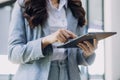 Woman hand using smart phone and laptop in outdoor nature park and sunset sky with bokeh light abstract background. Technology Royalty Free Stock Photo