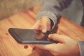 Woman hand using smartphone with cafe shop sunlight shade to object beautiful background. Royalty Free Stock Photo