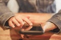 Woman hand using smartphone with cafe shop sunlight shade to object beautiful background. Royalty Free Stock Photo