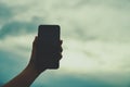 Woman hand using smartphone with cafe shop sunlight shade to object beautiful background. Royalty Free Stock Photo