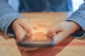 Woman hand using smartphone with cafe shop sunlight shade to object beautiful background. Royalty Free Stock Photo