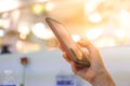 Woman hand using smartphone in mall Royalty Free Stock Photo