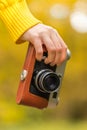 Woman hand with vintage retro photo camera outdoor Royalty Free Stock Photo