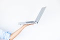 Woman hand waitress holding an empty computer laptop isolated on white background, Female waitress hand using computer laptop,