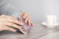 Woman hand wallet with cup of coffee