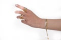 Woman hand wearing Snake Chain bracelets and Interlocked Golden and Silver Rings set against a white background. Beautiful Royalty Free Stock Photo