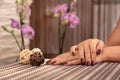 Elegant Wine: Female Hand with Wine Color Nails Polish and Decorative Ball in Beauty Studio Royalty Free Stock Photo