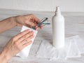 Woman hand wiping glasses with disinfectant wipes due to corona virus pandemic Royalty Free Stock Photo