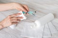 Woman hand wiping glasses with disinfectant wipes due to corona virus pandemic Royalty Free Stock Photo