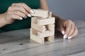 woman hand wooden cubes on tableÃÅ½