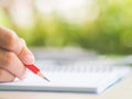 Woman hand working with calculator and holding red pencil Royalty Free Stock Photo