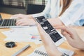 Woman hand working with phone and laptop on wooden desk in office. can be used on an ad Royalty Free Stock Photo