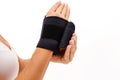 Woman hand with a wrist and finger brace, orthopeadic equipment over white Royalty Free Stock Photo