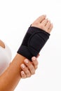 Woman hand with a wrist and finger brace, orthopeadic equipment over white Royalty Free Stock Photo