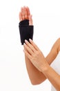 Woman hand with a wrist and finger brace, orthopeadic equipment over white