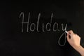 Embracing the Joy: Handwriting \'Holiday\' on Blackboard Royalty Free Stock Photo