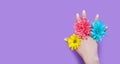 Woman hand and yellow, blue, pink flowers isolated on background. Summer and spring concept. Fashion design and manicure. Top view Royalty Free Stock Photo