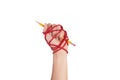 Woman hand with yellow pencil tied with red rope, depicting the idea of freedom of the press or freedom of expression on dark