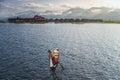 A woman with handcrafted colorful lotus fabrics on her boat in In Dain Khone village, on Inle Lake, Myanmar.