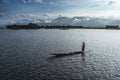 A woman with handcrafted colorful lotus fabrics on her boat in In Dain Khone village, on Inle Lake, Myanmar.