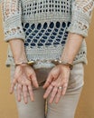 A woman is handcuffed while standing with her hands tied behind her back Royalty Free Stock Photo