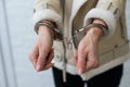 Woman handcuffs in criminal concept. Gray background. Royalty Free Stock Photo