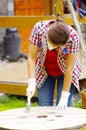 Woman with handgloves painting a wood table