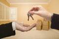 Woman Handing Over the House Keys Inside Empty Room