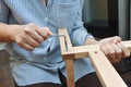 Woman hands assembling wooden furniture with tools during quarantine isolation Royalty Free Stock Photo