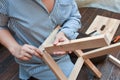 Woman hands assembling wooden furniture with tools during quarantine isolation Royalty Free Stock Photo