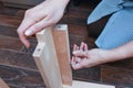 Woman hands assembling wooden furniture with tools during quarantine isolation Royalty Free Stock Photo