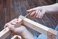 Woman hands assembling wooden furniture with tools during quarantine isolation Royalty Free Stock Photo